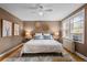 Cozy bedroom with a ceiling fan, ample natural light, and a radiator at 2867 Jasmine St, Denver, CO 80207