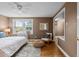 Cozy bedroom featuring hardwood floors, a vintage radiator, and a comfortable sitting area by the window at 2867 Jasmine St, Denver, CO 80207