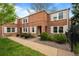 Charming brick townhome with well-maintained landscaping, offering an inviting curb appeal in a desirable neighborhood at 2867 Jasmine St, Denver, CO 80207