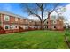 Charming brick townhomes with a large shared front lawn offering a sense of community and outdoor enjoyment at 2867 Jasmine St, Denver, CO 80207