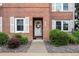 Inviting front door with wreath, set in a classic brick facade and surrounded by meticulously manicured landscaping at 2867 Jasmine St, Denver, CO 80207