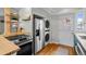 Efficient kitchen layout with stainless steel appliances and convenient washer/dryer combo at 2867 Jasmine St, Denver, CO 80207