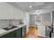 An open-concept kitchen, showcasing stainless steel appliances, white cabinets, and a cozy breakfast nook area at 2867 Jasmine St, Denver, CO 80207