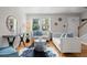 Bright living room boasts large windows, hardwood floors, and stylish modern furniture and decor at 2867 Jasmine St, Denver, CO 80207