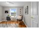 Bright and airy office space with hardwood floors, a glass desk, and natural light from a large window at 2867 Jasmine St, Denver, CO 80207