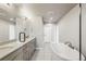 Spa-like bathroom with double vanity and a large soaking tub at 1694 Quitman St, Denver, CO 80204