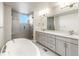 Elegant bathroom with double vanity, a large soaking tub, and shower at 1694 Quitman St, Denver, CO 80204