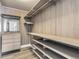 Large walk-in closet with custom shelving and hanging rods at 1694 Quitman St, Denver, CO 80204