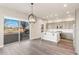 Modern kitchen with gray cabinets, white island, and stainless steel appliances at 1694 Quitman St, Denver, CO 80204