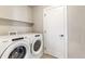 Bright laundry room with Whirlpool washer and dryer at 1694 Quitman St, Denver, CO 80204