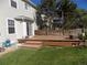 A wooden deck outside the sliding doors with a grassy backyard and privacy fence at 7982 S Kittredge Way, Englewood, CO 80112