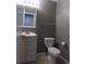 Cozy half bathroom with a tile floor, a single sink, and toilet at 7982 S Kittredge Way, Englewood, CO 80112