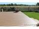 A nice looking deck with a grassy area and wooden fence in the background at 7982 S Kittredge Way, Englewood, CO 80112