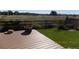 A beautiful deck overlooking a grassy area with sunflowers and a wooden fence at 7982 S Kittredge Way, Englewood, CO 80112