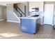 Open concept kitchen with stainless appliances and stairs nearby at 7982 S Kittredge Way, Englewood, CO 80112