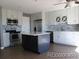 Well-lit kitchen with stainless steel appliances and a gray kitchen island at 7982 S Kittredge Way, Englewood, CO 80112