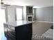 Bright living room with fireplace and kitchen island at 7982 S Kittredge Way, Englewood, CO 80112