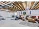Unfinished basement showcasing exposed beams, a workout area, and cozy seating space at 4585 High Mesa Cir, Castle Rock, CO 80108