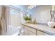 Well-lit bathroom offers a shower and tub, neutral vanity, and stylish fixtures at 4585 High Mesa Cir, Castle Rock, CO 80108