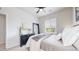 Bright bedroom with natural light showcases a comfortable bed and classic dark-toned decor and furniture at 4585 High Mesa Cir, Castle Rock, CO 80108