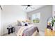 Cozy bedroom with ceiling fan features a comfortable bed, soft pillows, and a sunlit window at 4585 High Mesa Cir, Castle Rock, CO 80108