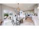 Dining area with stylish lighting, a view of the backyard, and open access to the modern kitchen at 4585 High Mesa Cir, Castle Rock, CO 80108