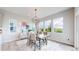 Bright dining room features a modern chandelier, large windows, and stylish decor and furniture at 4585 High Mesa Cir, Castle Rock, CO 80108