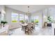 Bright dining room boasts large windows, modern lighting, and easy access to the outdoor patio at 4585 High Mesa Cir, Castle Rock, CO 80108