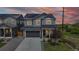Charming two-story home with grey siding, solar panels, and a well-manicured lawn at dusk at 4585 High Mesa Cir, Castle Rock, CO 80108