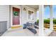 Inviting front porch with stone accents, chairs, a wreath, and outdoor decor at 4585 High Mesa Cir, Castle Rock, CO 80108
