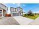 Charming two-story home with a gray exterior, well-manicured lawn, and long driveway at 4585 High Mesa Cir, Castle Rock, CO 80108