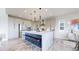 Modern kitchen with a large island, stainless steel appliances, and stylish pendant lighting at 4585 High Mesa Cir, Castle Rock, CO 80108