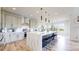 Modern kitchen featuring a large island with seating, stainless steel appliances, and stylish pendant lighting at 4585 High Mesa Cir, Castle Rock, CO 80108