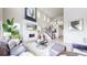 Bright, open living room with soaring ceilings, fireplace and an elegant staircase at 4585 High Mesa Cir, Castle Rock, CO 80108