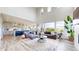 Open concept living room with high ceilings, large windows, and a modern kitchen in the background at 4585 High Mesa Cir, Castle Rock, CO 80108