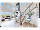 Elegant living room with a staircase, fireplace, large windows, and an open concept design at 4585 High Mesa Cir, Castle Rock, CO 80108