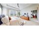 Bright primary bedroom featuring tray ceilings, a large window, and a modern cabinet at 4585 High Mesa Cir, Castle Rock, CO 80108