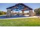 Park pavilion with stone pillars and picnic tables on green grass at 4585 High Mesa Cir, Castle Rock, CO 80108