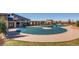 Community pool with lounge area, covered for the season, surrounded by green lawn at 4585 High Mesa Cir, Castle Rock, CO 80108