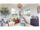 Bright sitting area with two windows offering neighborhood views, stylish decor, and cozy furnishings at 4585 High Mesa Cir, Castle Rock, CO 80108