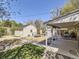 Expansive backyard with a mix of features, including a covered patio, shed, and play area at 3341 Oneida St, Denver, CO 80207