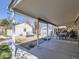 Outdoor covered patio and backyard featuring two storage sheds at 3341 Oneida St, Denver, CO 80207