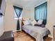 Cozy bedroom with wood floors, a comfortable daybed, and soft, natural lighting at 3341 Oneida St, Denver, CO 80207