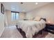 Basement bedroom with plush carpets, neutral paint, and an egress window at 3341 Oneida St, Denver, CO 80207