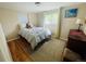 Cozy bedroom features hardwood floors, a large window, and neutral paint colors at 3341 Oneida St, Denver, CO 80207