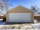Detached two car garage with white door is perfect for parking and storage at 3341 Oneida St, Denver, CO 80207