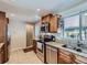 Well-lit kitchen featuring stainless steel appliances, granite countertops, and ample wooden cabinetry at 3341 Oneida St, Denver, CO 80207