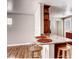 Stylish kitchen island featuring granite countertop, wooden bar stools, and open shelving at 3341 Oneida St, Denver, CO 80207
