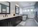 Elegant bathroom with double vanity, soaking tub, a standup shower, and stylish fixtures throughout at 6610 Barnstead Dr, Castle Pines, CO 80108