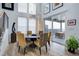 Elegant dining room with high ceilings, modern light fixture, and sliding door access to the deck at 6610 Barnstead Dr, Castle Pines, CO 80108